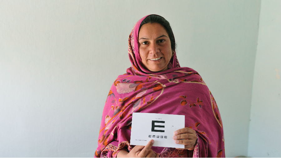 Amber Naz holding an eye chart