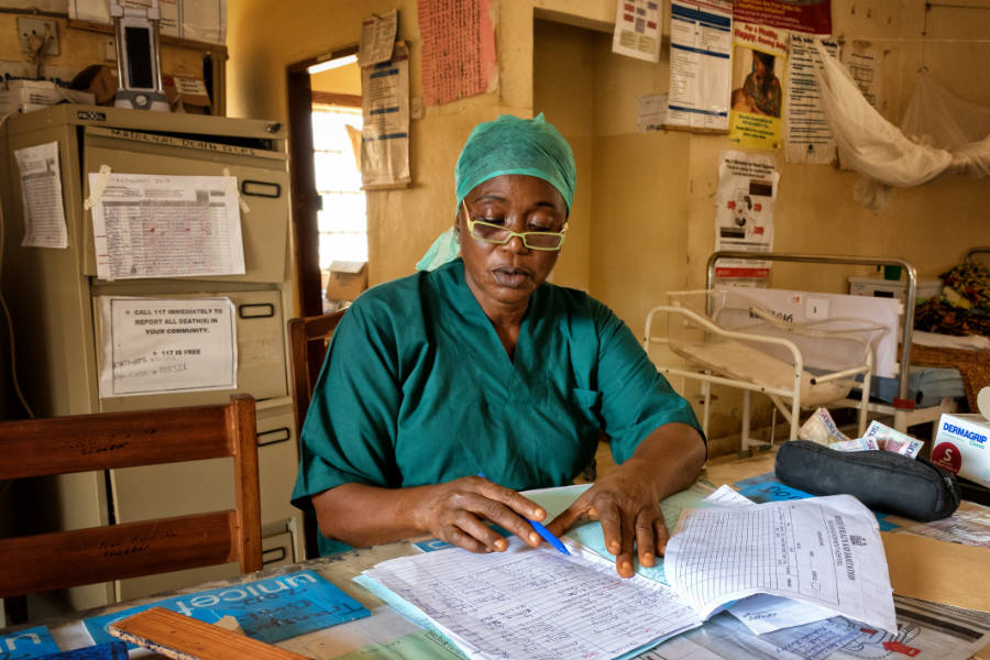 An eye health nurse doing paperwork in an office