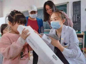 Child looks at an eye care device