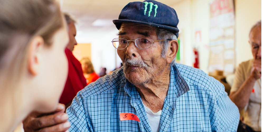 A man tries on his first pair of eyeglasses