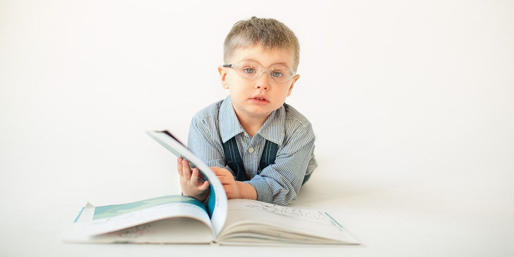 Spectacled child with an open book