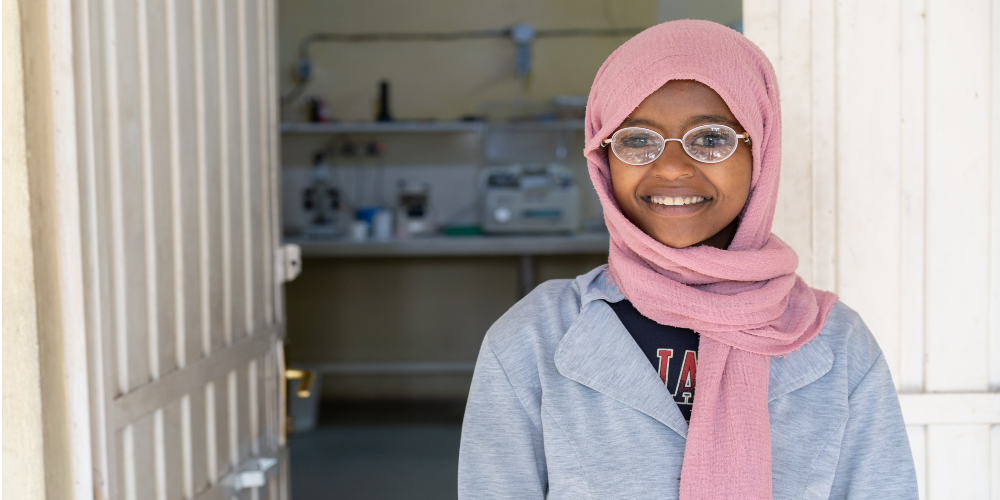 Smiling girl with her glasses