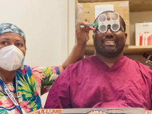 Health worker who needs refraction and is done in a Covid storage room by Laite Tuma