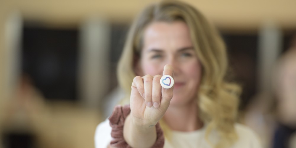 Holly holding Love Your Eyes button