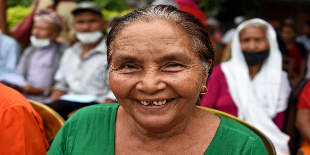 A woman smiling after having her sight restored.