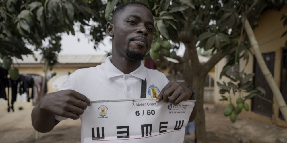 Community Health Nurse Isaac Baiden assesses a villager’s visual acuity in Jei Krodua, Awutu Senya District in Ghana’s Central Region.