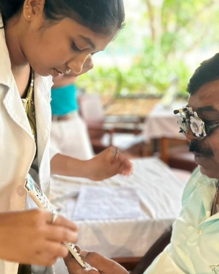 A man sitting getting his eyes tested.