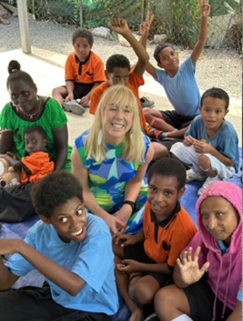 Caroline Casey sat surrounded by children of African heritage