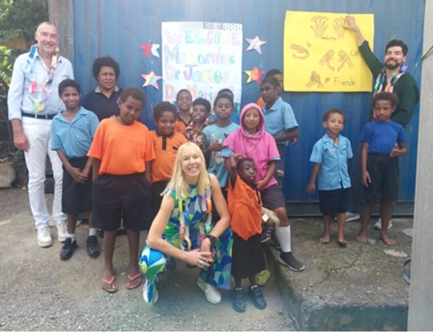 Caroline Casey knelt surrounded by children of African heritage
