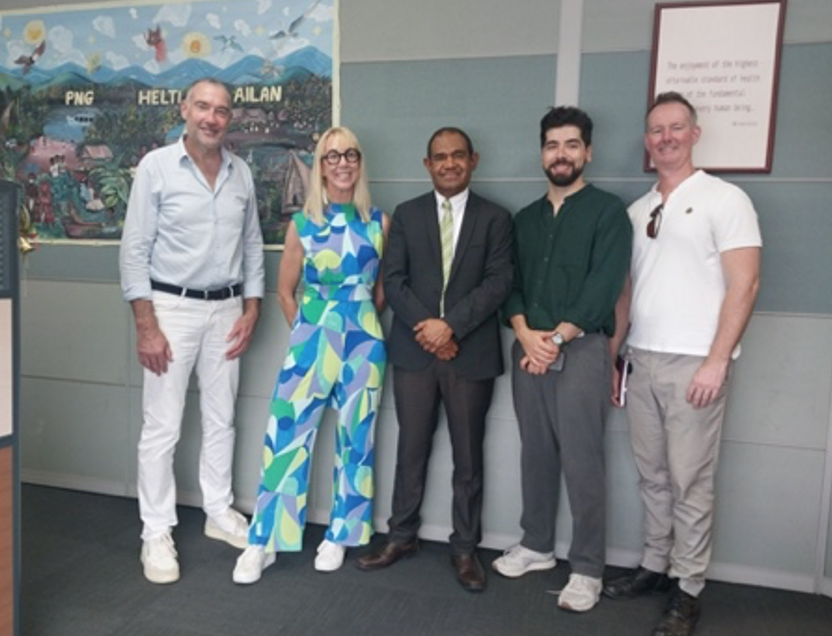 Caroline Casey stood with 4 other men posing for a picture