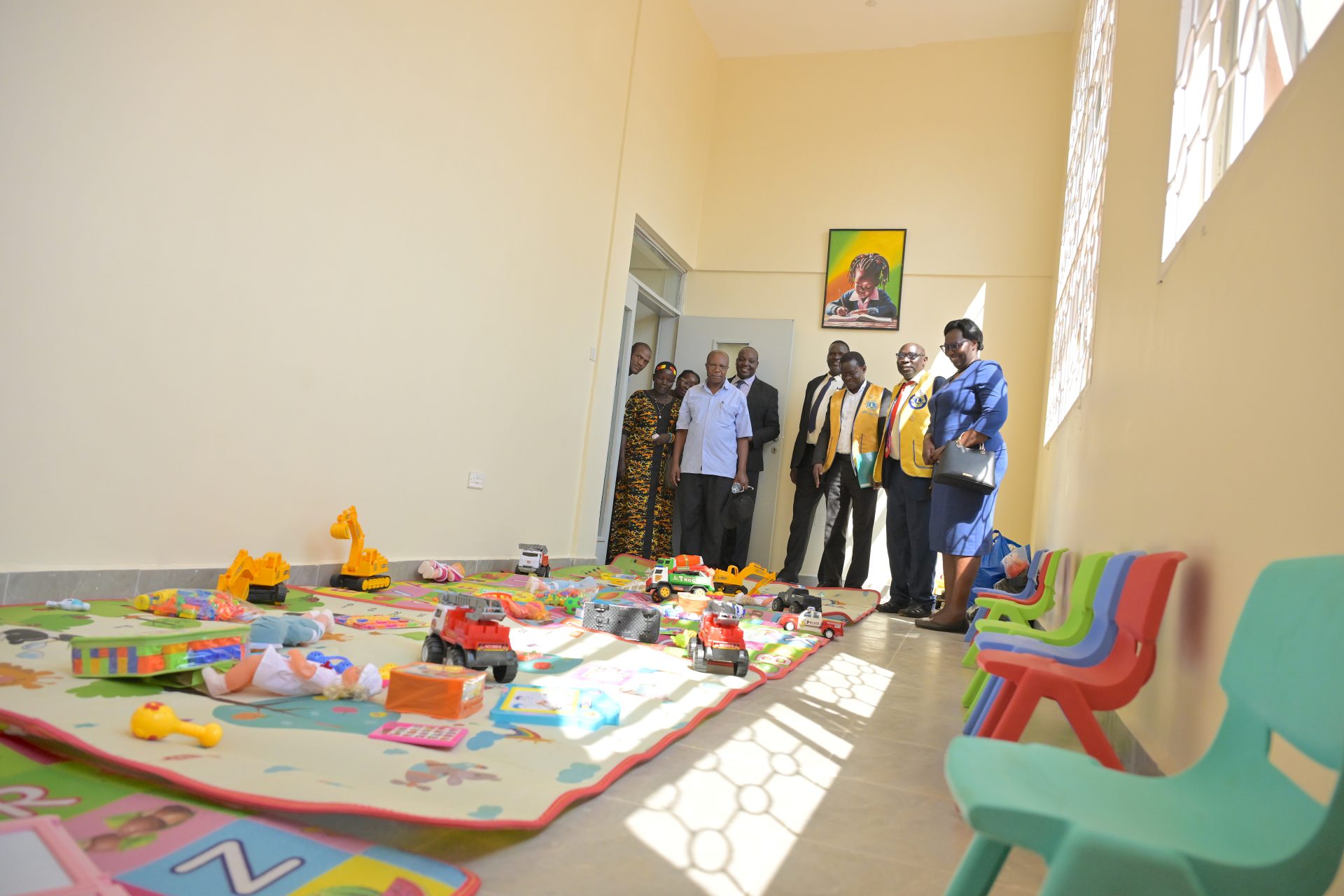 Visit to a playroom: Members of Lion´s rClub International Uganda with the Chief Guest (Dr Alex Wasomoka - Assistant Commissioner in the Ministry of Health in Uganda, representing the Minister of Health - background)
