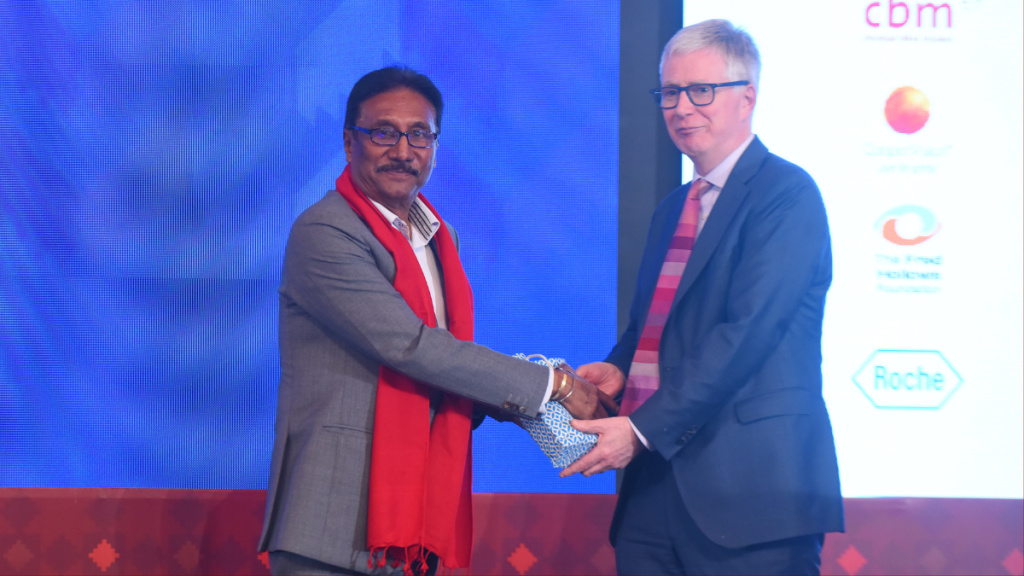 The Minister for Labour, Employment and Social Security in Nepal, Honourable Sharad Singh Bhandari and IAPB CEO, Peter Holland on stage in Nepal