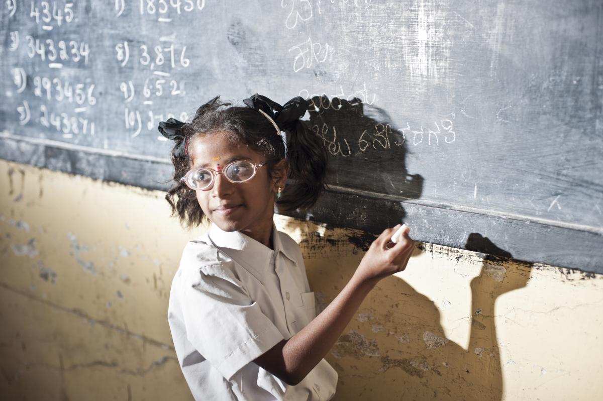 School girl writing on the board