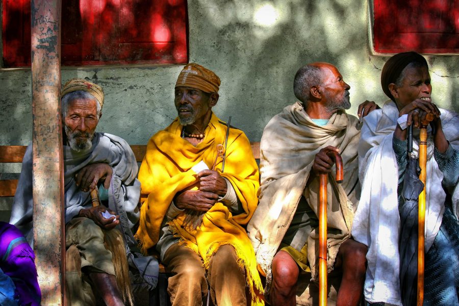 Patients sitting on a bench waiting for an eye test