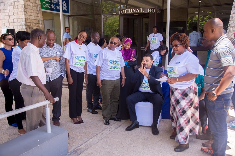 Mr. Sanjay Rughani (CEO) Standard Chartered Bank Tanzania having his visual acuity tested during the screening of SCB staff.