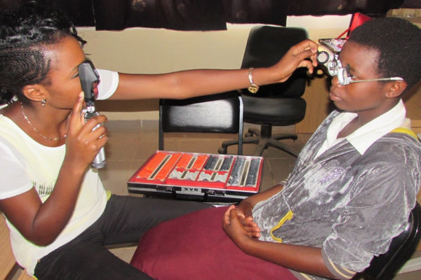 A BICO community eye care worker optometry technician conducting an eye test of one of the BICO c