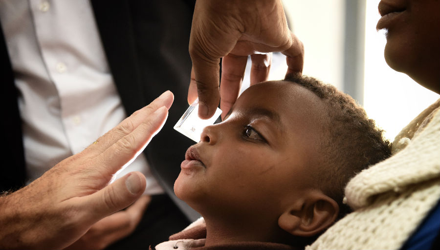 A child being examined onboard the Orbis Flying Hospital/ Story: Orbis: Saving Vision and Changing Children’s Lives Across the World