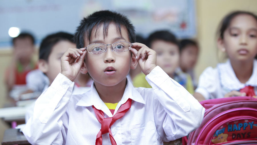 A child surprised to see clearly after wearing new glasses by Nguyen Thi Quynh Nhu/ Story: Webinar: Advancing Access to Vision-related Assistive Technology 