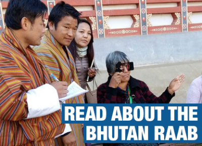 An image from the Bhutan RAAB of surveyors screening an old lady