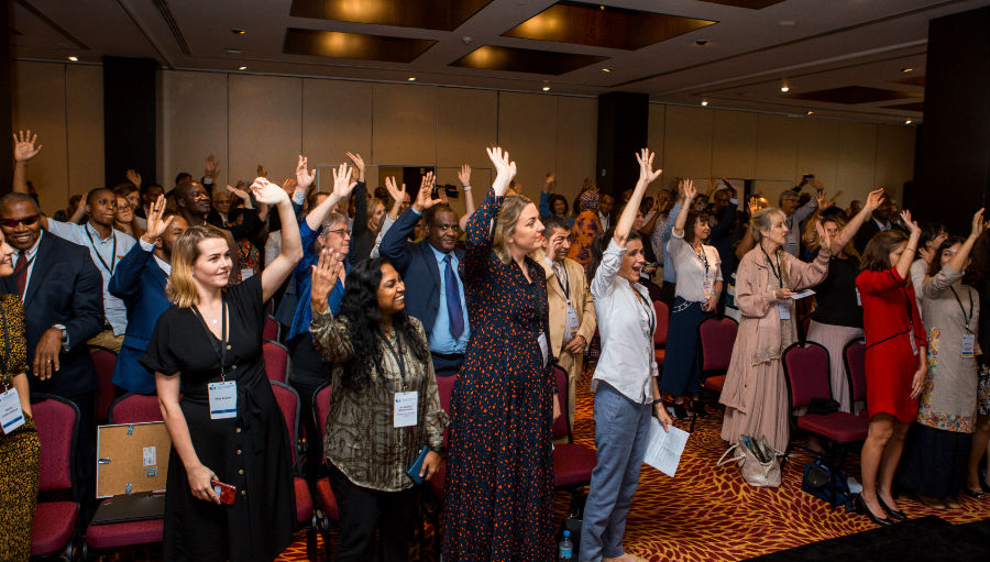 COM19 delegates raise their hands/ Story: Council of Members Experience