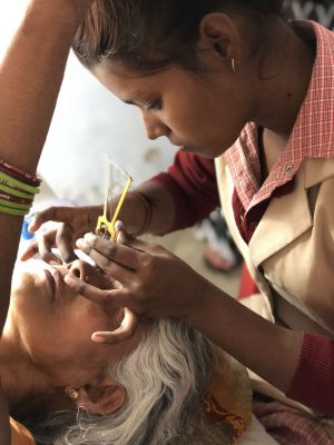 COP graduate measuring a patients eye pressure