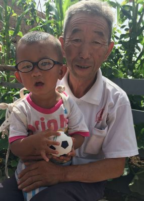 Chunsheng with his grandpa after congential cataract surgery