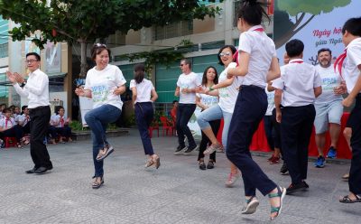 SCB staff dancing with students