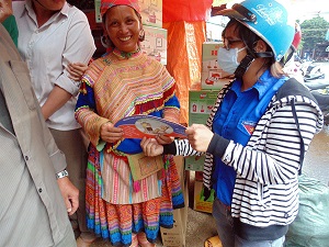 Delivering IEC materials to local people in Dak Nong