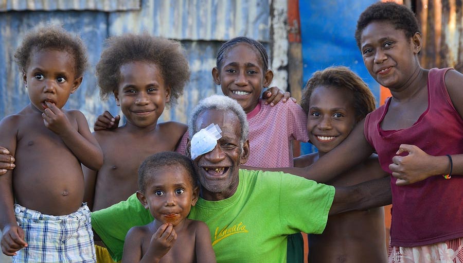 Avoidable blindness. Photo of an old man after cataract surgery with his family. Photo courtesy: Fred Hollows Foundation New Zealand