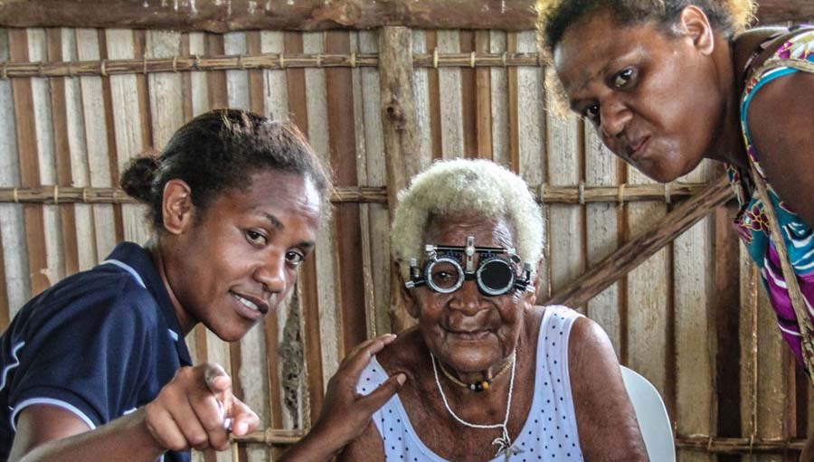 Opt In: Gender Equity baseline. Explaining Vision Testing to an old woman during a Village Screening. FHFNZ, Papua New Guinea