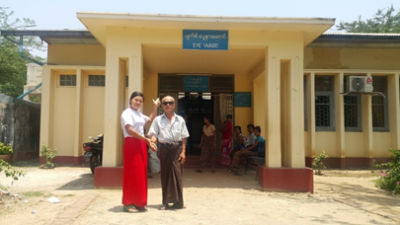 A midwife in Sagaing district, Myanmar, with a cataract patient outside a rural health facility 