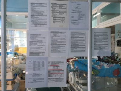 Clinical guidelines attached to walls on the unit