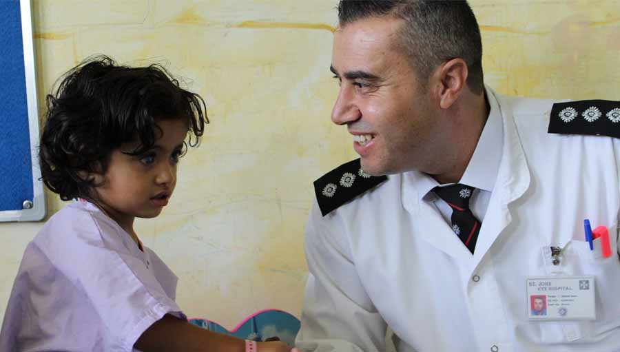 Day in the life of a Nurse Manager. Photo: Two year old Rimas holds hands with nurse Ahmed Amer; Submitted by: Marie-Claire Boyle; St John of Jerusalem Eye Hospital