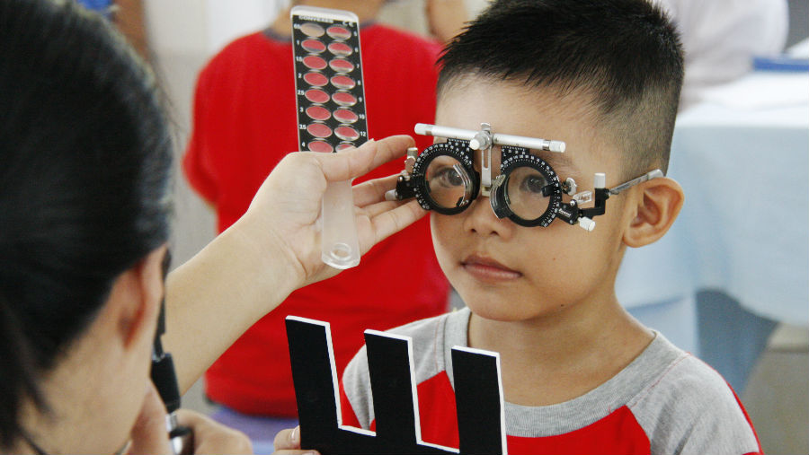 A child gets his eyes tested