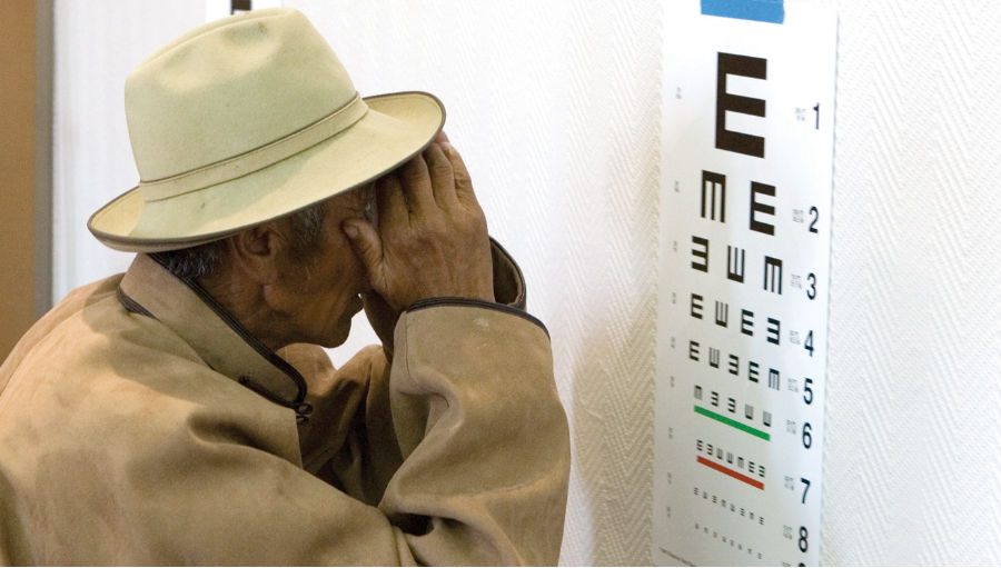 Man checking his eyesight/ Story:Expanding mobile vision clinics in rural Laos