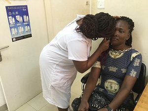 Ophthalmic nurse Rebecca Kissi examines a patient’s eyes during a routine exam at Tarkwa Municipal Hospital in Ghana.