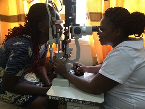 Ophthalmic nurse Rebecca Kissi tests a patient’s vision at Tarkwa Municipal Hospital in Ghana, using a slit lamp that screens for diseases or abnormalities in the eye. 