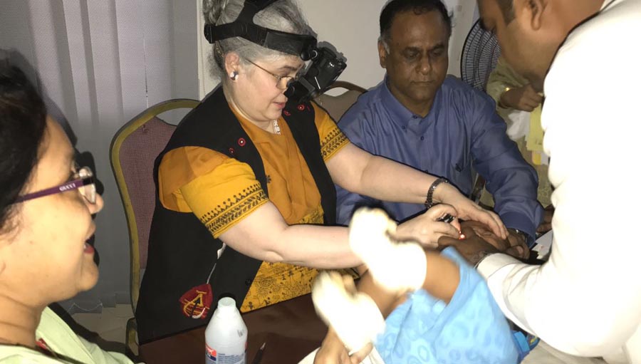 Dr Subhadra Jalali, examining the eye of a newborn