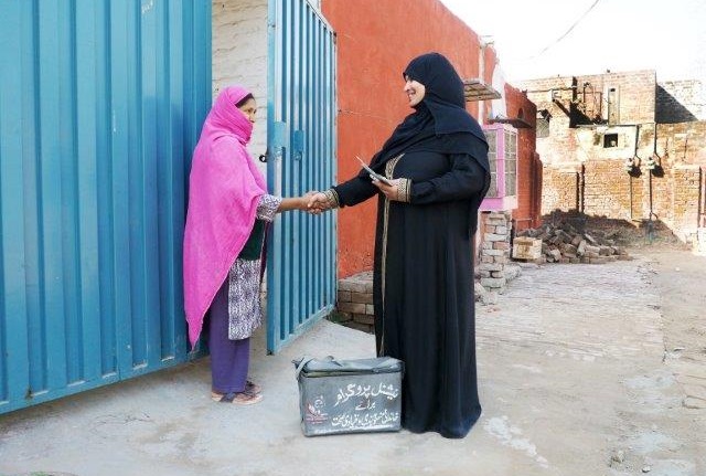 Lady health worker visiting community members in Pakistan