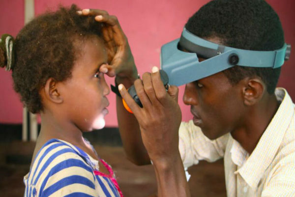 A young girl is examined for Trachoma