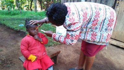 Stella examines a young girl in the community